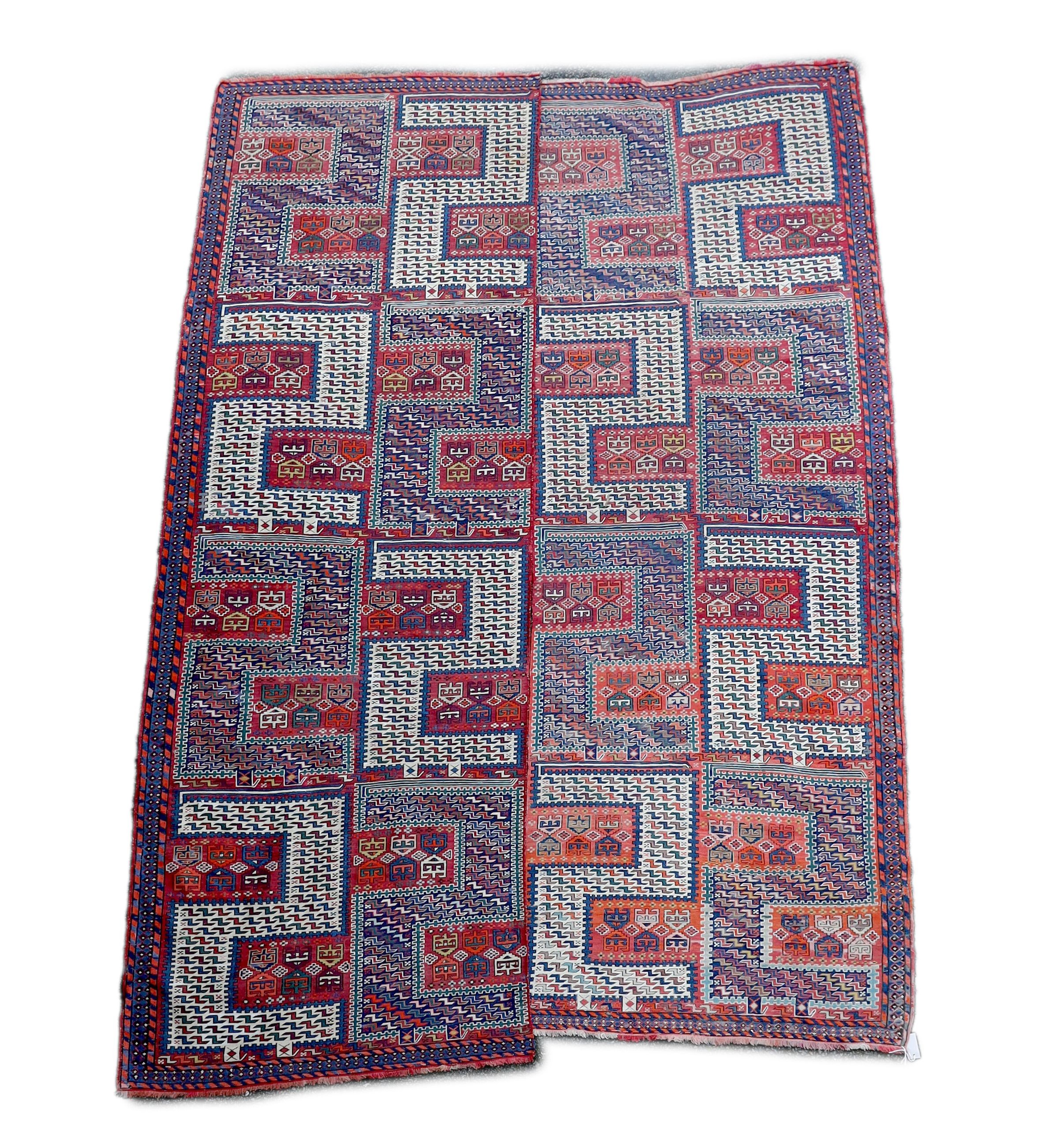 A Sumak weave 2-sectional carpet, combined dimension - 320 x 230cm.